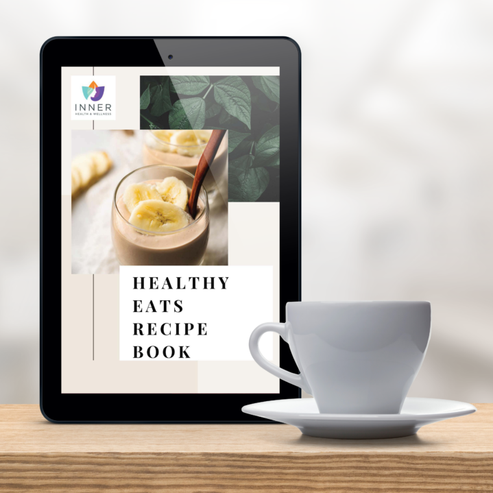 Inner Health Wellness Recipe book cover on tablet along with tea on wooden table